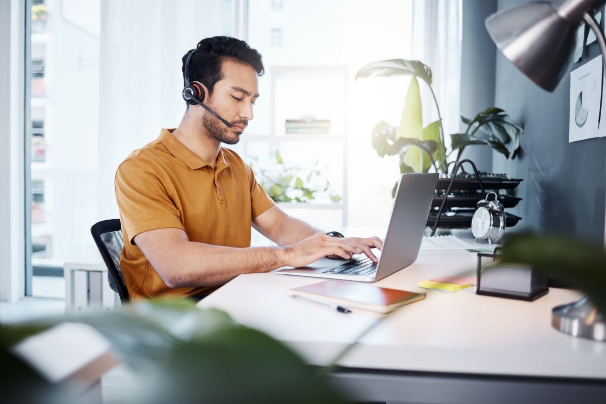 customer-service-laptop-office-focus-man-typing-response-contact-us-communication-ecommerce-telemarketing-sales-pitch-e-commerce-male-callcenter-consultant-working-online-support (1)